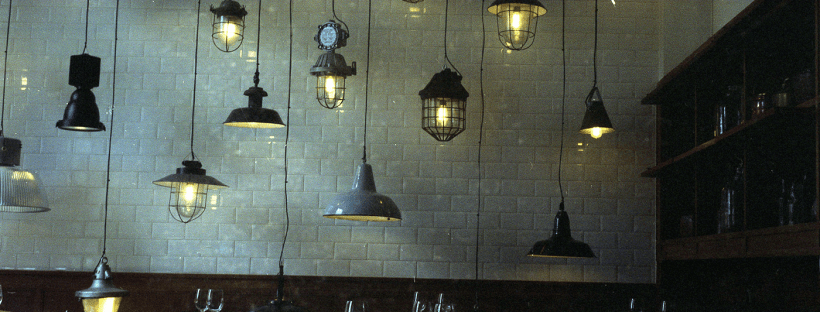 Hanging pendant lights against a brick wall